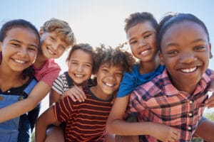 a group of children smiling for a picture. back to school dental habits