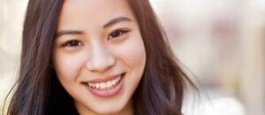 a close-up of a woman's face who had dental bonding treatment. Patient with gum health concerns.